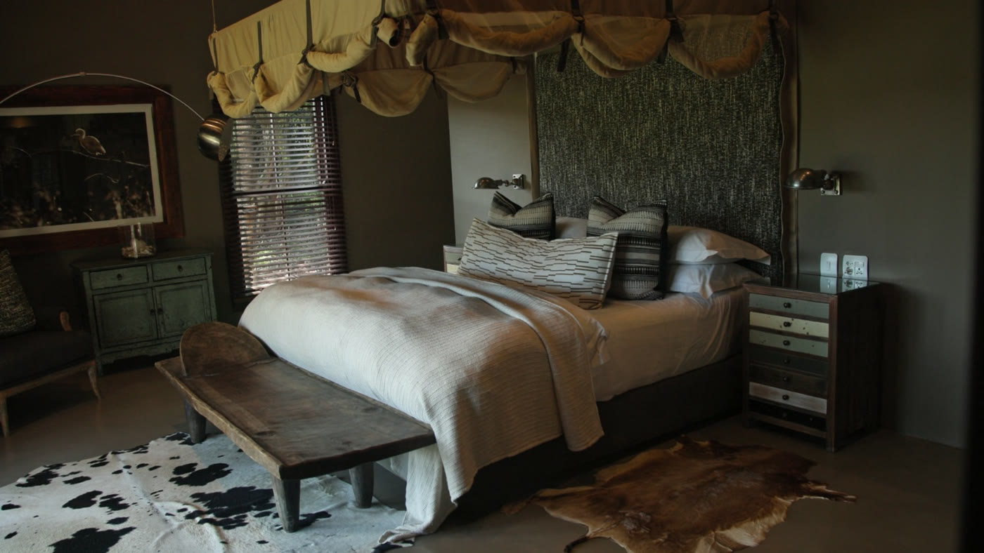 Luxury safari lodge bedroom with canopy bed